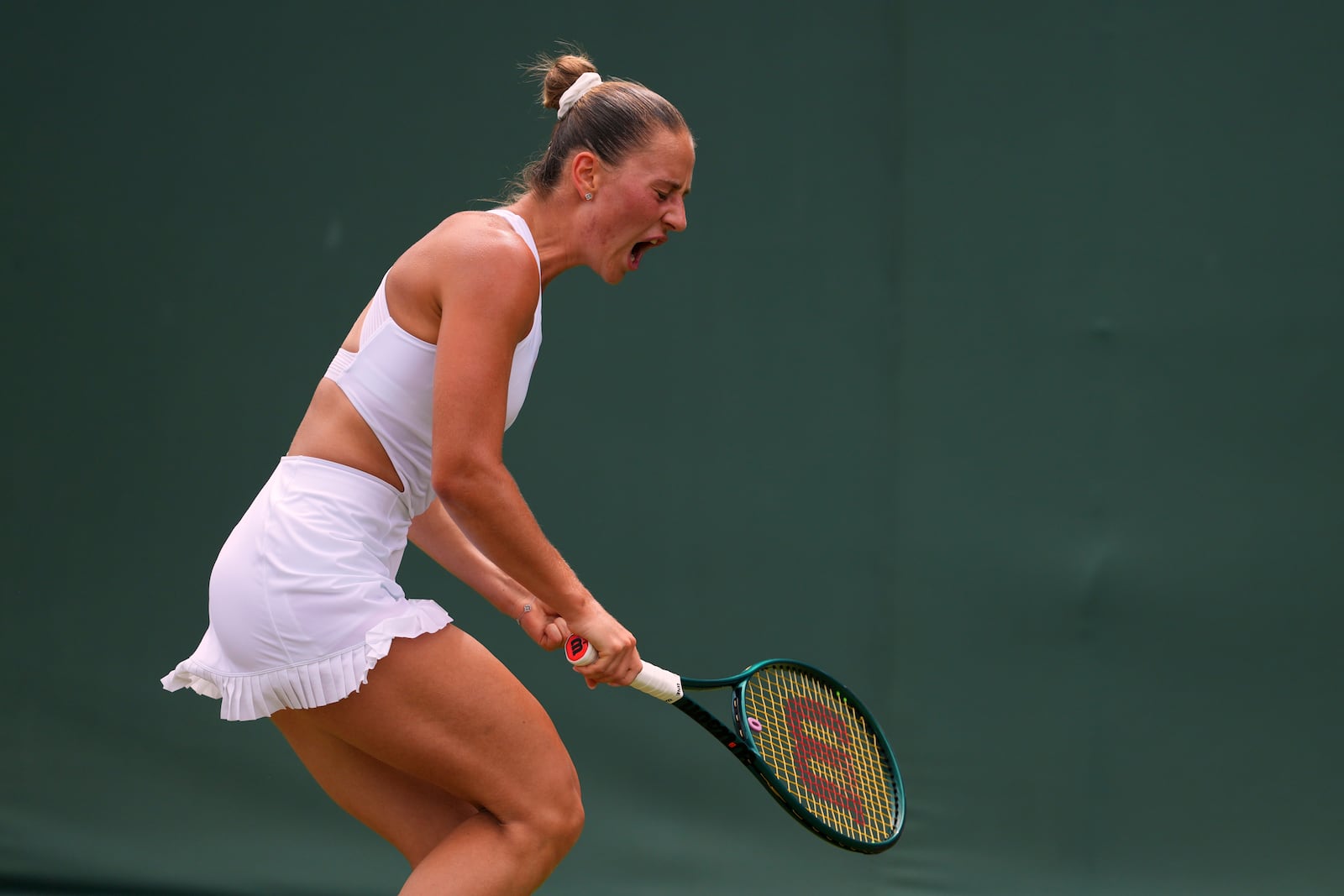Marta Kostyuk of Ukraine celebrates winning a point against Veronika Erjavec of Slovenia during their first round women's singles match at the Wimbledon Tennis Championships in London, Tuesday, July 1, 2025.(AP Photo/Kirsty Wigglesworth)