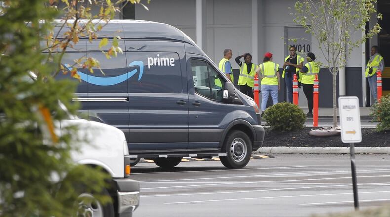 Amazon is ramping up its operation in the Kettering Business Park. Delivery vans have been filling the parking lots of the distribution center for about three weeks. TY GREENLEES / STAFF