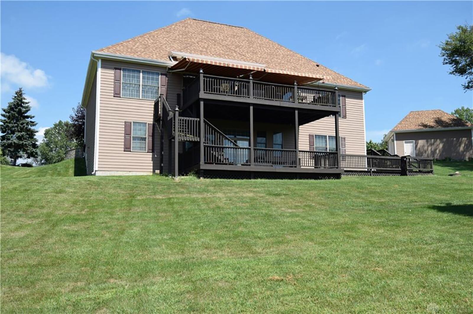 The back of the property features two wrap-around, screened-in porches, double connected brick patios and pathways to the front. There is also outdoor lighting and wooded views. CONTRIBUTED PHOTO