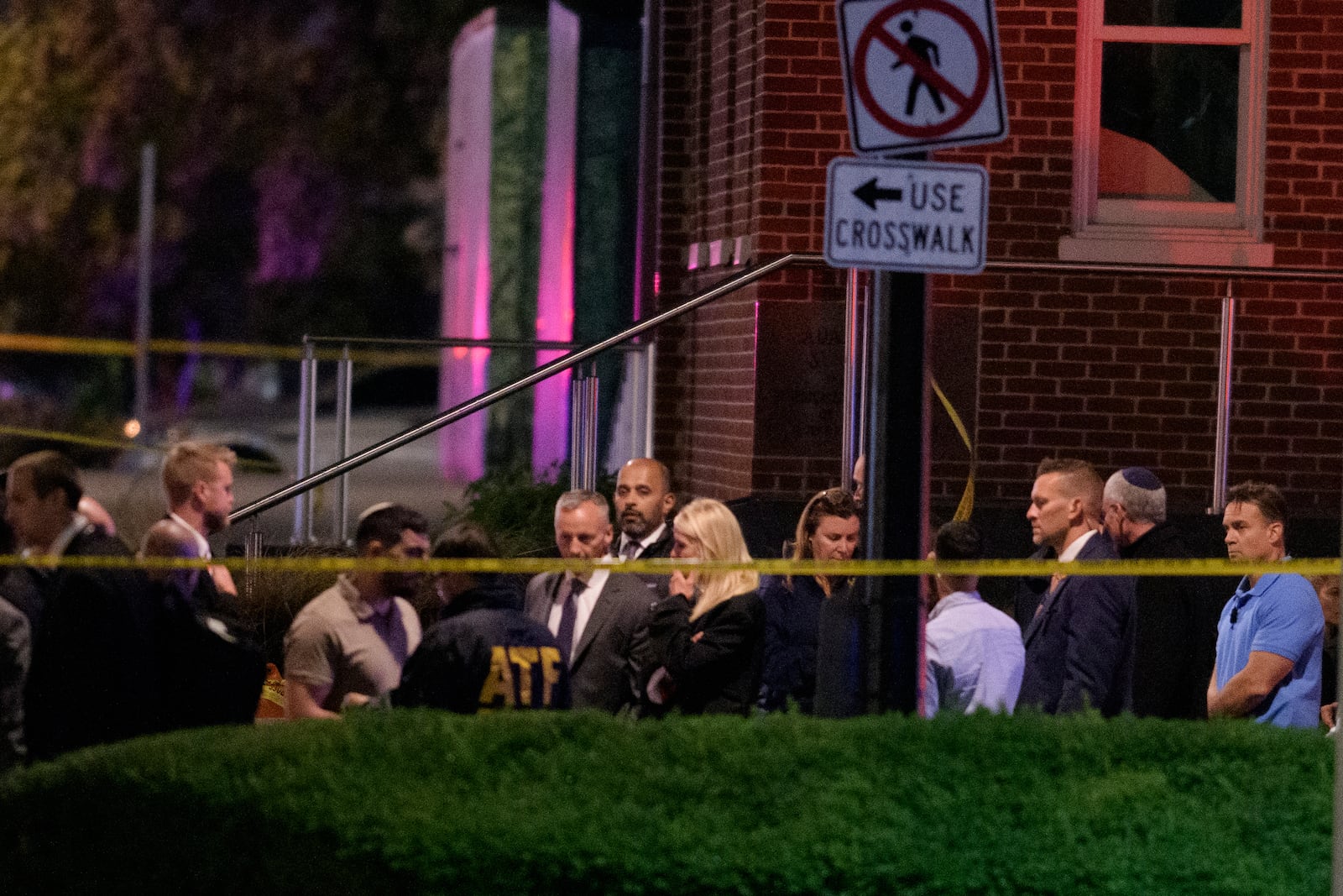 Attorney General Pam Bondi, center, walks to her car as law enforcement work the scene after two staff members of the Israeli Embassy in Washington were shot and killed outside the Capital Jewish Museum, Thursay, May 22, 2025, in Washington. (AP Photo/Rod Lamkey, Jr.)