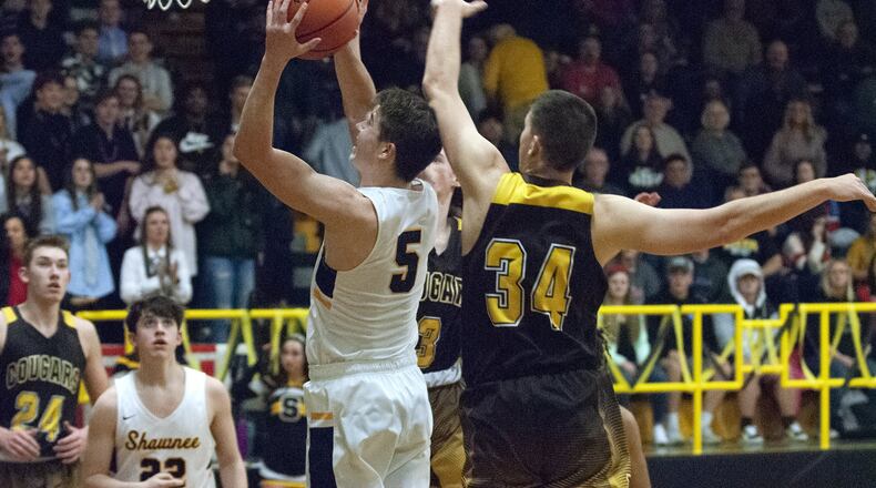 Shawnee senior Isaac Siemon scores inside against Kenton Ridge’s Collin Perkins on Friday night at Shawnee on senior night. Siemon scored 33 points to lead the Braves to a 70-55 victory. Jeff Gilbert/CONTRIBUTED