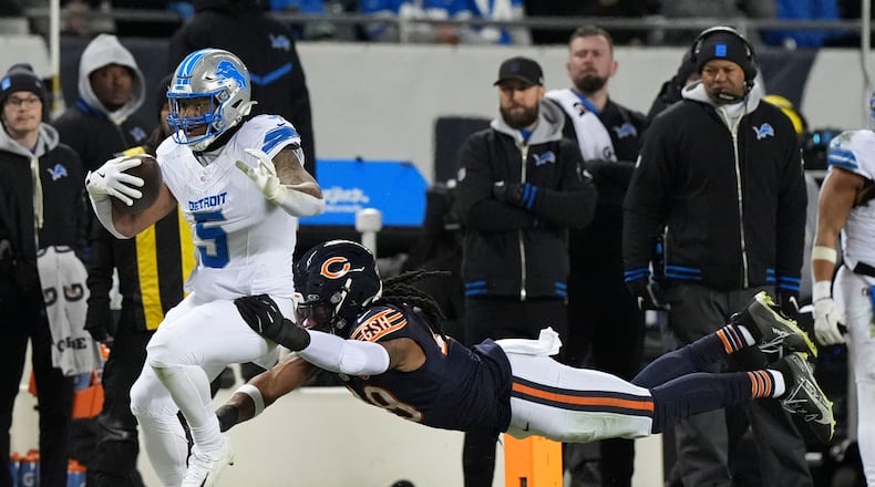 FILE - Detroit Lions running back David Montgomery runs from Chicago Bears linebacker Tremaine Edmunds during the second half of an NFL football game, Jan. 4, 2026, in Chicago. (AP Photo/Nam Y. Huh, file)