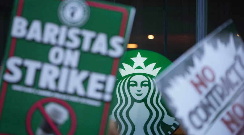 Protesters picket outside a Starbucks, Thursday, Nov. 13, 2025, in Philadelphia. (AP Photo/Matt Slocum)