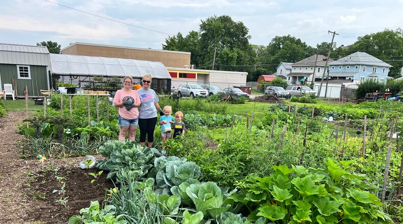 Rachael Hardin, left, is a mother taking part in a Springfield City School District program at the Jefferson Street Oasis Garden. Her children, Naomi and Robert Hardin, are at right, next to Machael Zeigler, a parent educator employed by the school district. CONTRIBUTED