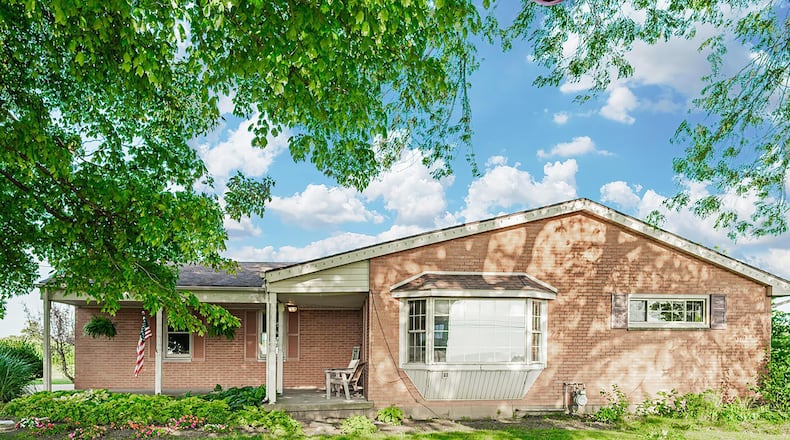 The front of the home has an L-shaped concrete covered porch, a bay window and two-car attached, side-entry garage. Contributed