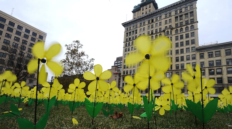 Representatives from the Alzheimer’s Association and members of Boy Scout Pack 151 from Oakwood planted 1,000 yellow pinwheel flowers at Levitt Pavilion in November to honor Alzheimer’s caregivers during National Caregivers Month. MARSHALL GORBY\STAFF