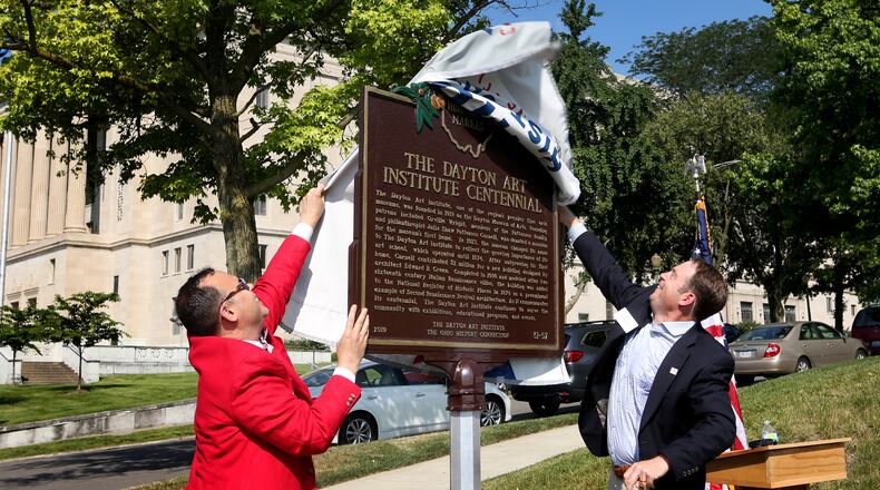 Michael Roediger, director and CEO of the Dayton Art Institute (left), and Brock Anderson III, chair of the board of trustees, unveil an Ohio Historical Marker commemorating the 100th year of the Dayton Art Institute on Tuesday, July 2. LISA POWELL / STAFF