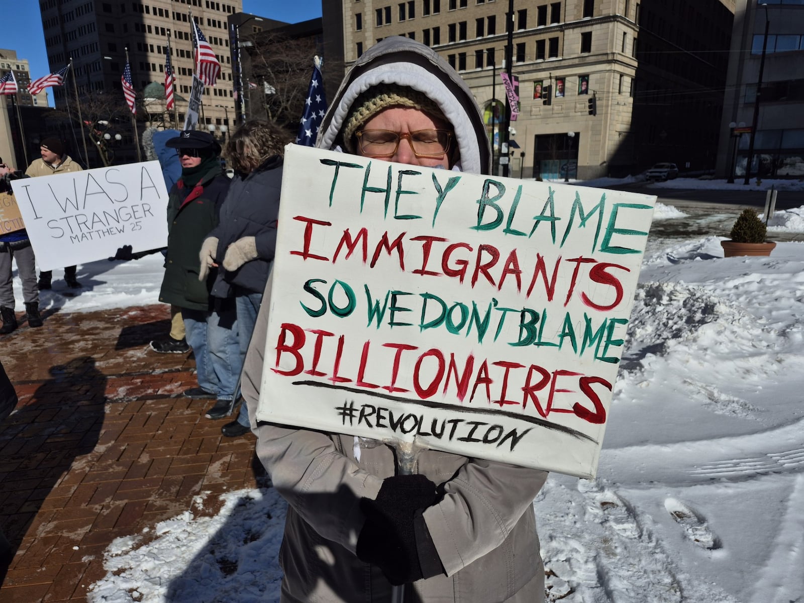 Many of the 125 plus protestors on Courthouse Square in Dayton Saturday carried hand-made signs calling for the abolishing of ICE, permanent status for refugees, and tolerance for immigrants. MICHAEL KURTZ / STAFF