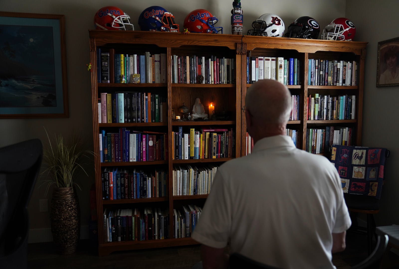 Philip McLemore, A former Latter-day Saints Air Force and hospice chaplain, sits facing a shrine he uses in his yoga and meditation practice, at his home in Eagle Mountain, Utah, on Thursday, April 24, 2025. (AP Photo/Jessie Wardarski)