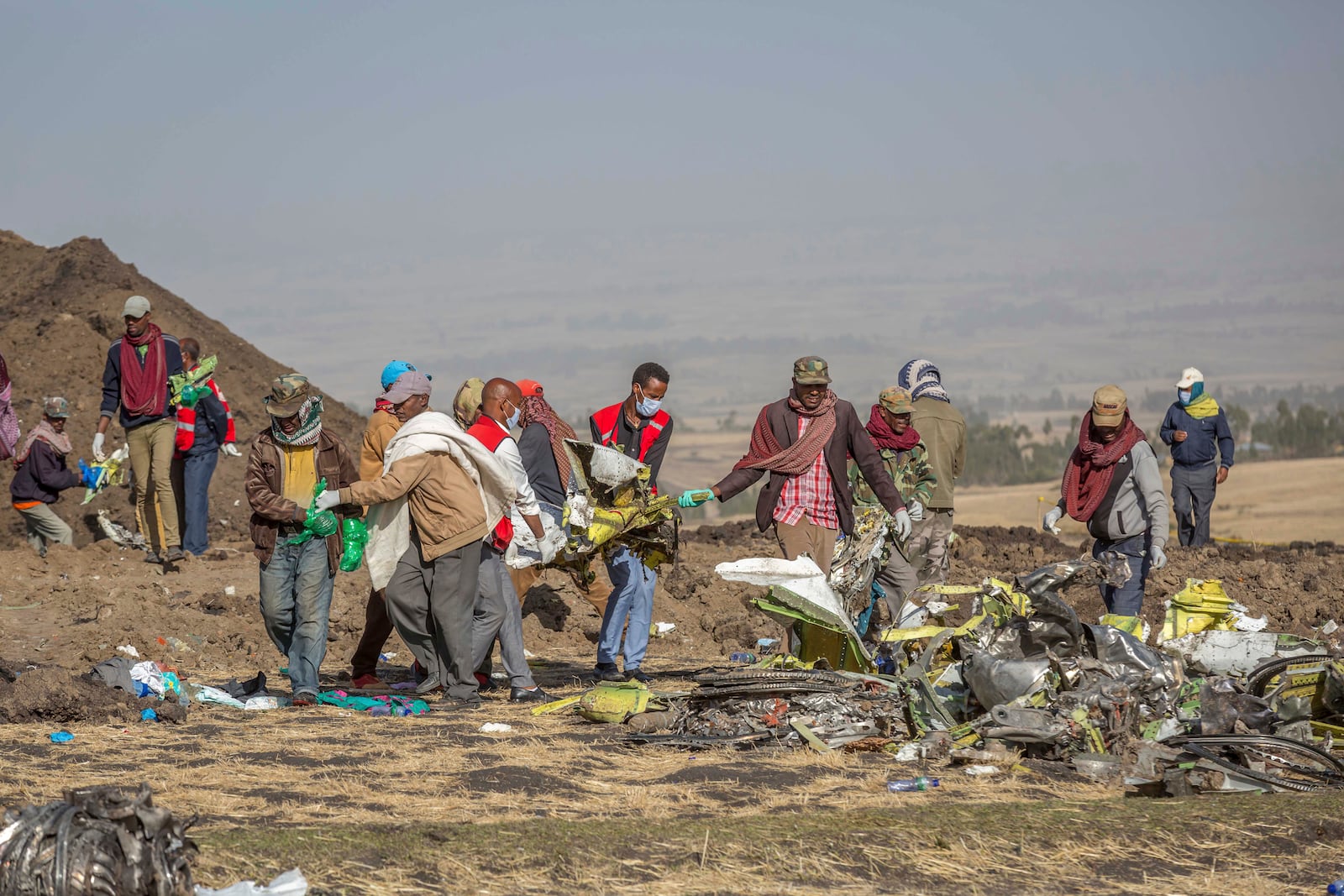 FILE - Rescuers work at the scene of an Ethiopian Airlines flight of a Boeing 737 Max 8 plane crash near Bishoftu, or Debre Zeit, south of Addis Ababa, Ethiopia, March 11, 2019. (AP Photo/Mulugeta Ayene, File)