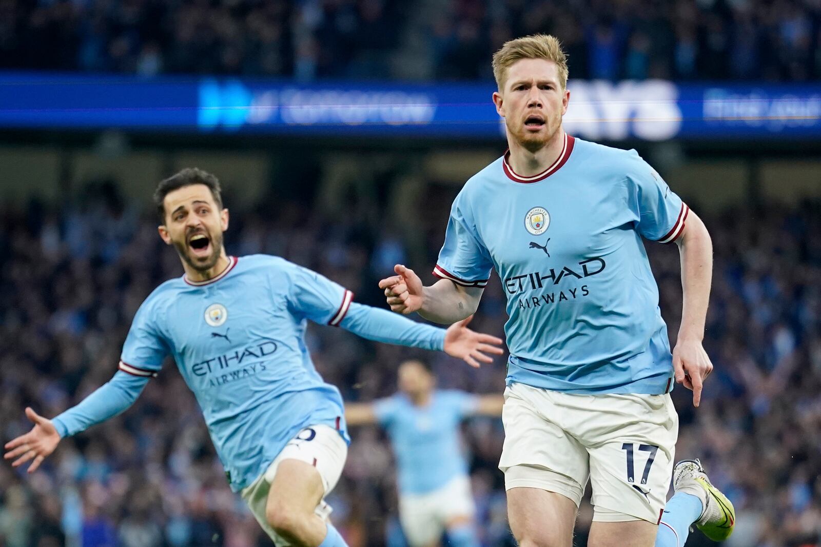 FILE - Manchester City's Kevin De Bruyne celebrates with Manchester City's Bernardo Silva, left, after scoring the opening goal during the English Premier League soccer match between Manchester City and Arsenal at Etihad stadium in Manchester, England, Wednesday, April 26, 2023. (AP Photo/Dave Thompson, file)