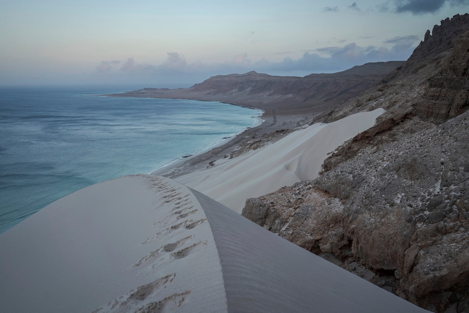 Sand dunes plunge into the sea on the Yemeni island of Socotra on Sept. 21, 2024. (AP Photo/Annika Hammerschlag)