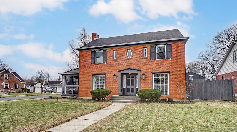 This brick two story sits on a corner lot and has a two car detached garage.