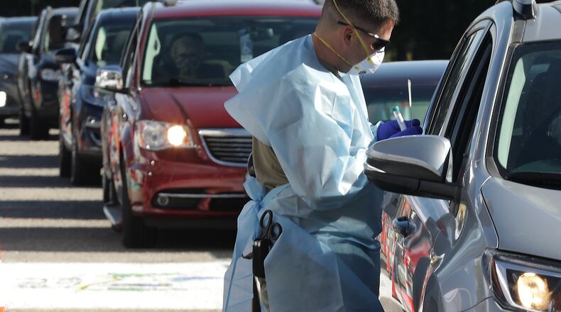 The Clark County Combined Health District held a free drive-thru COVID-19 testing clinic in the parking lot of Kenton Ridge High School Friday. BILL LACKEY/STAFF
