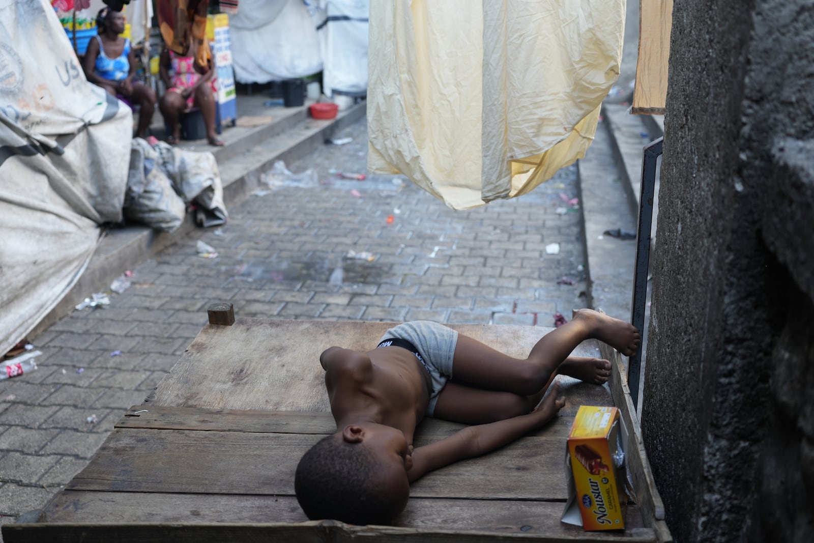 A child sleeps at a shelter for families displaced by gang violence in Port-au-Prince, Haiti, Tuesday, Jan. 27, 2026. (AP Photo/Odelyn Joseph)
