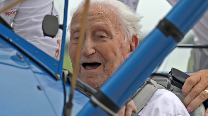 World War II veteran Ed Fisher, who recently turned 100 years-old, smiles after taking a Dream Flight in a restored Boeing Stearman biplane at Grimes Field in Urbana. Ed was a NAVY pilot and actually trained in a Stearman biplane. BILL LACKEY/STAFF