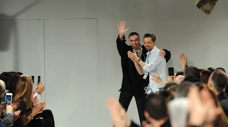 FILE - Raf Simons, left, chief creative officer, and Pieter Mulier, creative director, greet the audience after presenting their Calvin Klein runway show during Fashion Week in New York, Friday, Feb. 10, 2017. (AP Photo/Diane Bondareff, File)