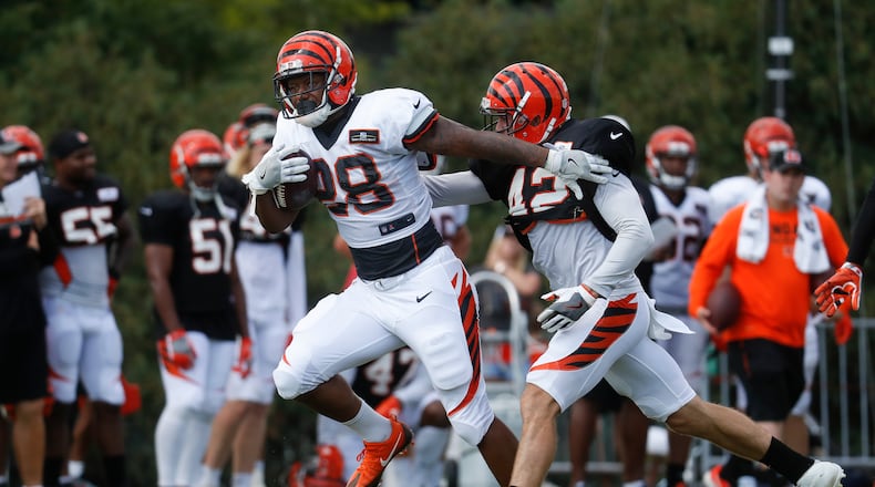 Cincinnati Bengals running back Joe Mixon, left, runs past safety Clayton Fejedelem, right, during NFL football training camp, Monday, July 31, 2017, in Cincinnati. (AP Photo/John Minchillo)