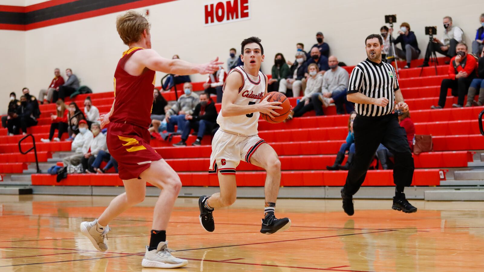 Cedarville High School senior Payton Herron is guarded by Northeastern's Cole Allen during their game on Tuesday night in Cedarville. CONTRIBUTED PHOTO BY MICHAEL COOPER