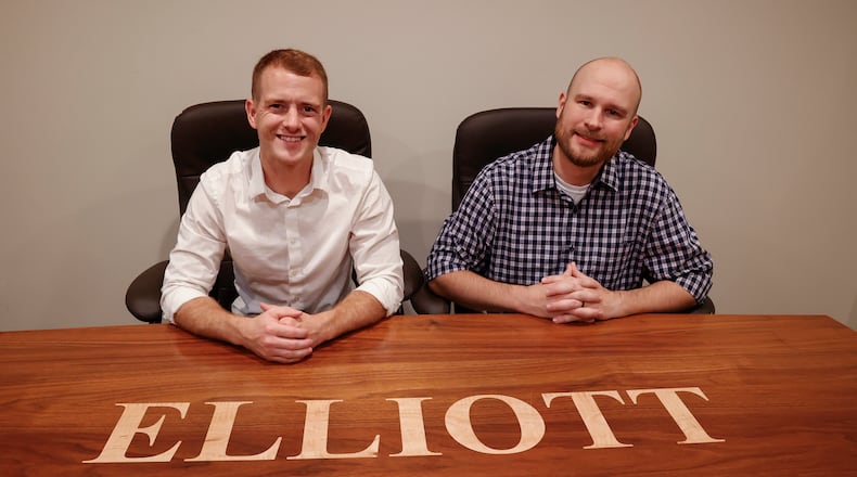 Co-owners Tim Elliott III, left, and Tim Sloan pose for a portrait in their Elliott Insurance office on Wednesday, Aug. 6, 2025, in Springfield. They're also brothers-in-law. JOSEPH COOKE/STAFF