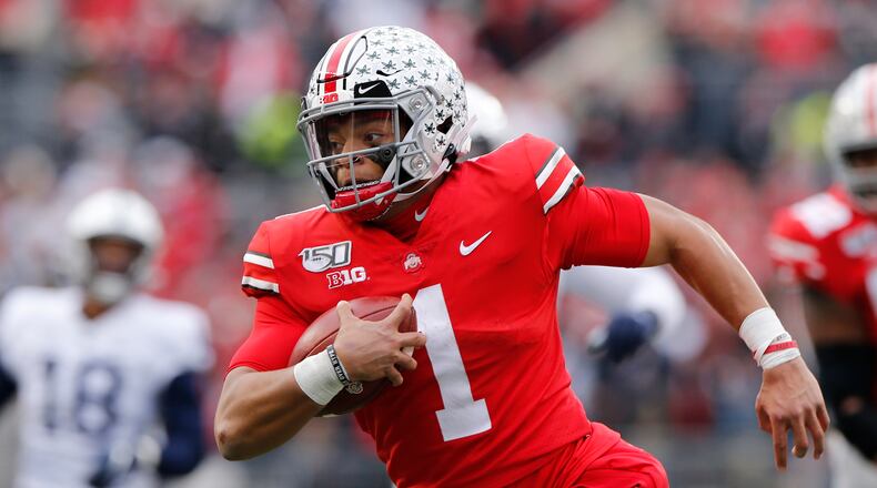 FILE - In this Nov. 23, 2019, file photo, Ohio State quarterback Justin Fields plays against Penn State during an NCAA college football game, in Columbus, Ohio. (AP Photo/Jay LaPrete, File)
