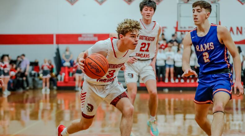 Southeastern High School senior Zach McKee is guarded by Greeneview senior Chase Allen during their game on Tuesday night in South Charleston. The Trojans won 58-44. Michael Cooper