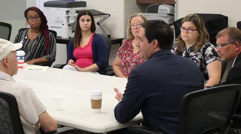 Ohio Secretary of State Frank LaRose talks with workers at the Clark County Board of Elections Thursday before a tour of the facility. BILL LACKEY/STAFF
