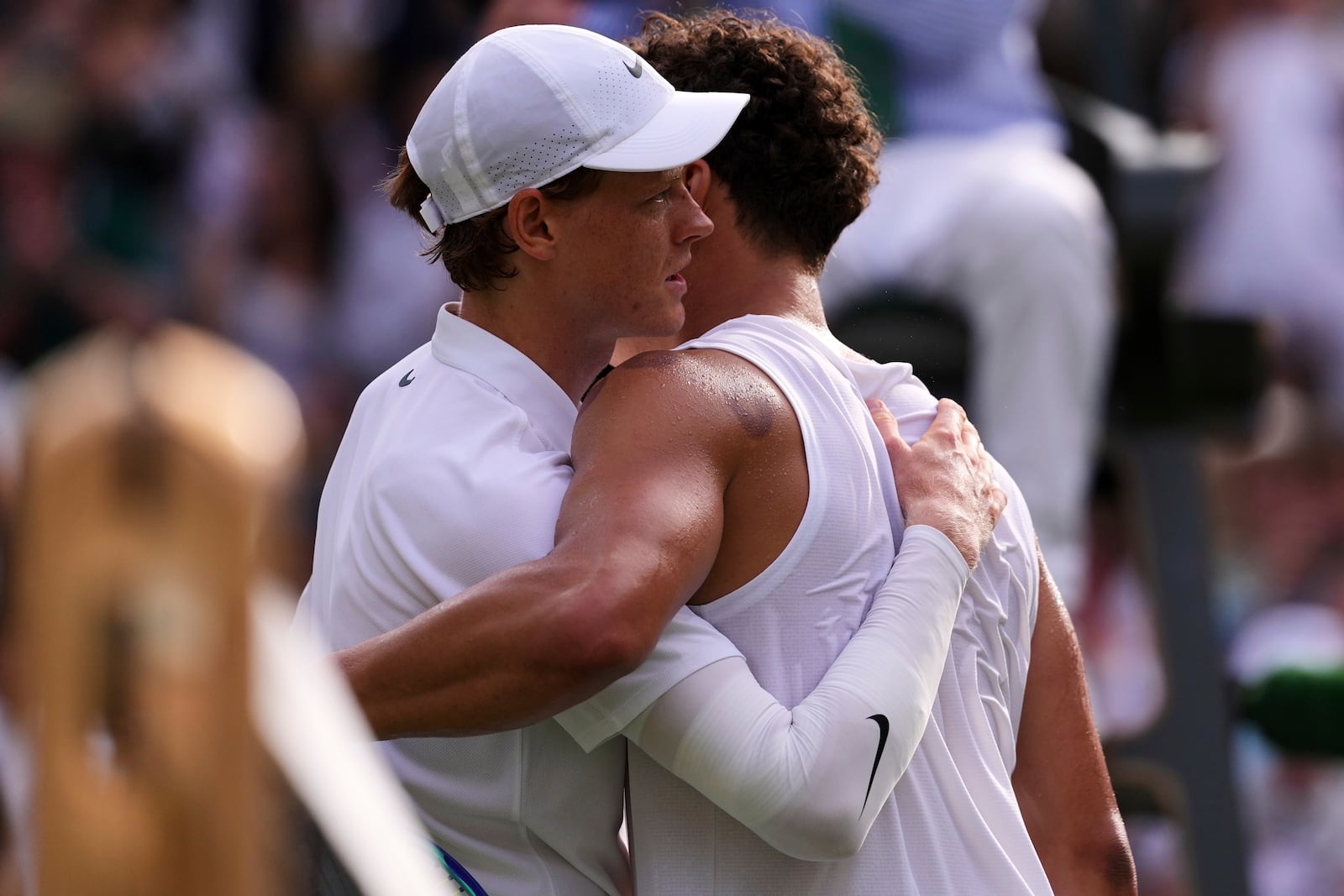 Jannik Sinner of Italy and Ben Shelton of the U.S. hug after the men's singles quarter final match at the Wimbledon Tennis Championships in London, Wednesday, July 9, 2025.(AP Photo/Kirsty Wigglesworth)