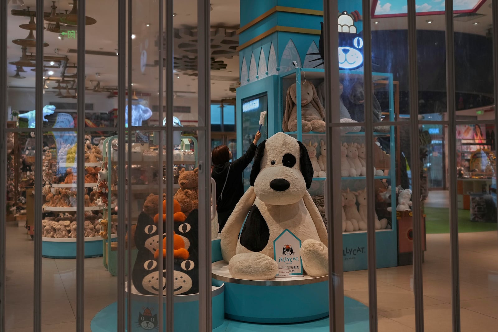 A staff member wipes a shelf at the American toy store FAO Schwarz before it opens business at a popular shopping mall in Beijing, Friday, May 9, 2025. (AP Photo/Andy Wong)