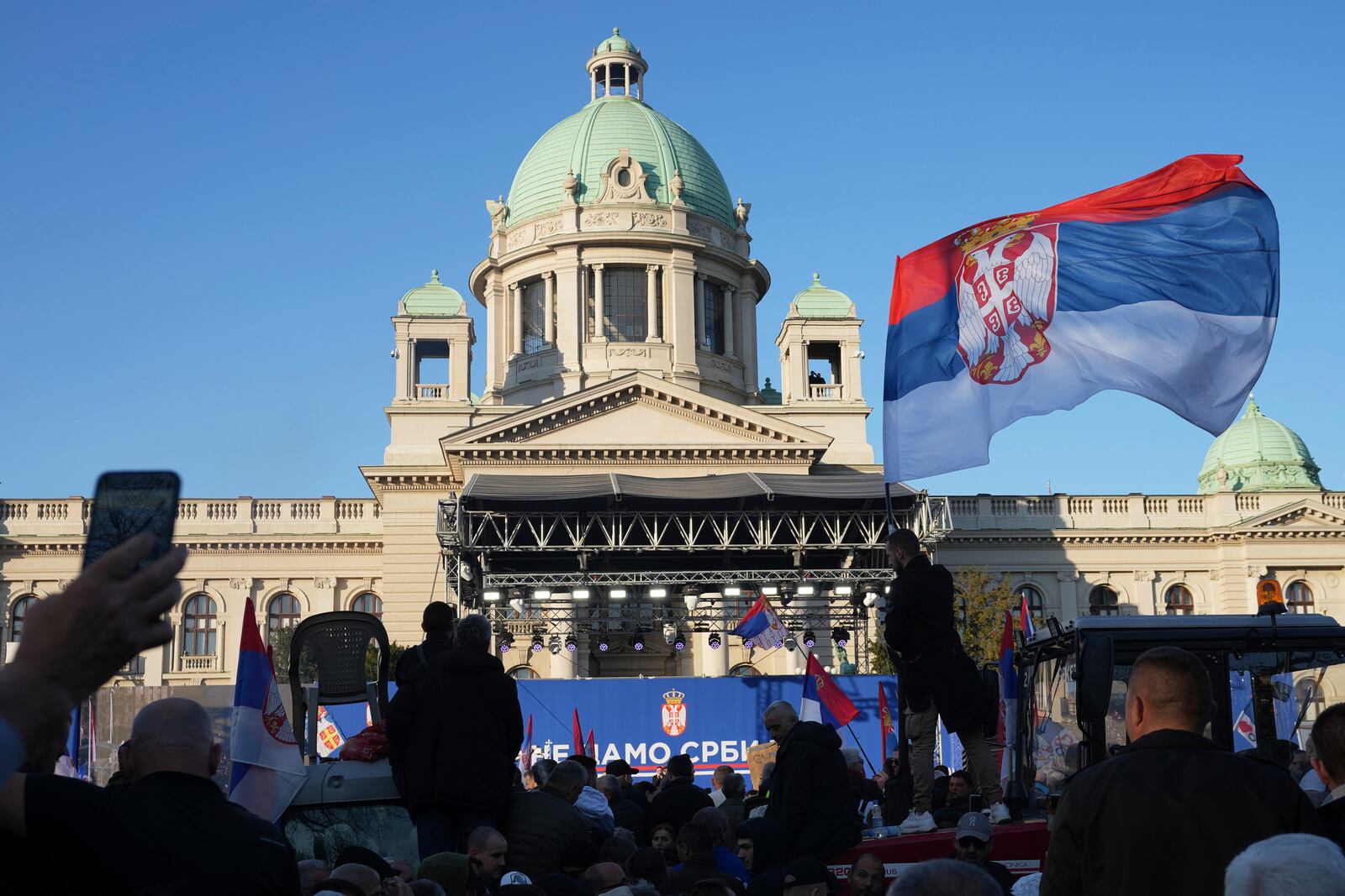 Supporters of Serbia's President Aleksandar Vucic gather during a rally in his support, apparently designed to counter student-led gatherings, in Belgrade, Serbia, Saturday, April 12, 2025. (AP Photo/Darko Vojinovic)