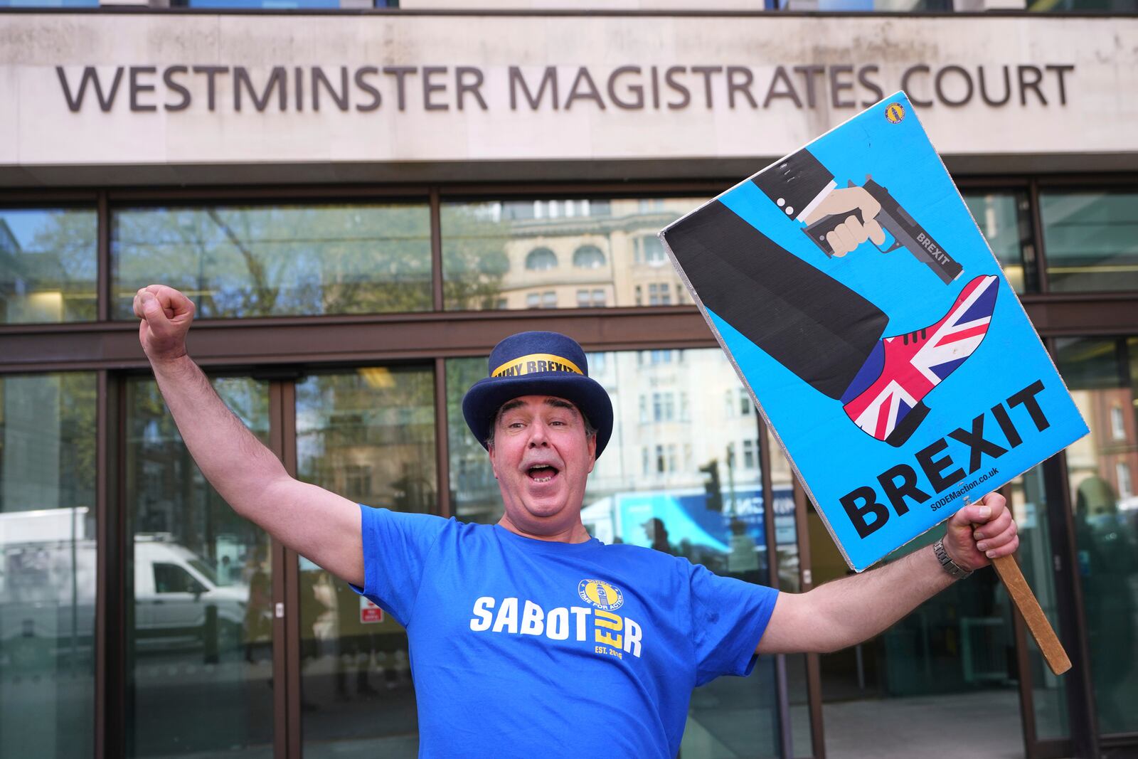 Anti-Brexit campaigner Steve Bray celebrates as he leaves Westminster Magistrates Court in London, Monday, April 14, 2025, after he has been found not guilty to failing without reasonable excuse to comply with a direction given under the Police Reform and Social Responsibility Act 2011. (AP Photo/Kirsty Wigglesworth)