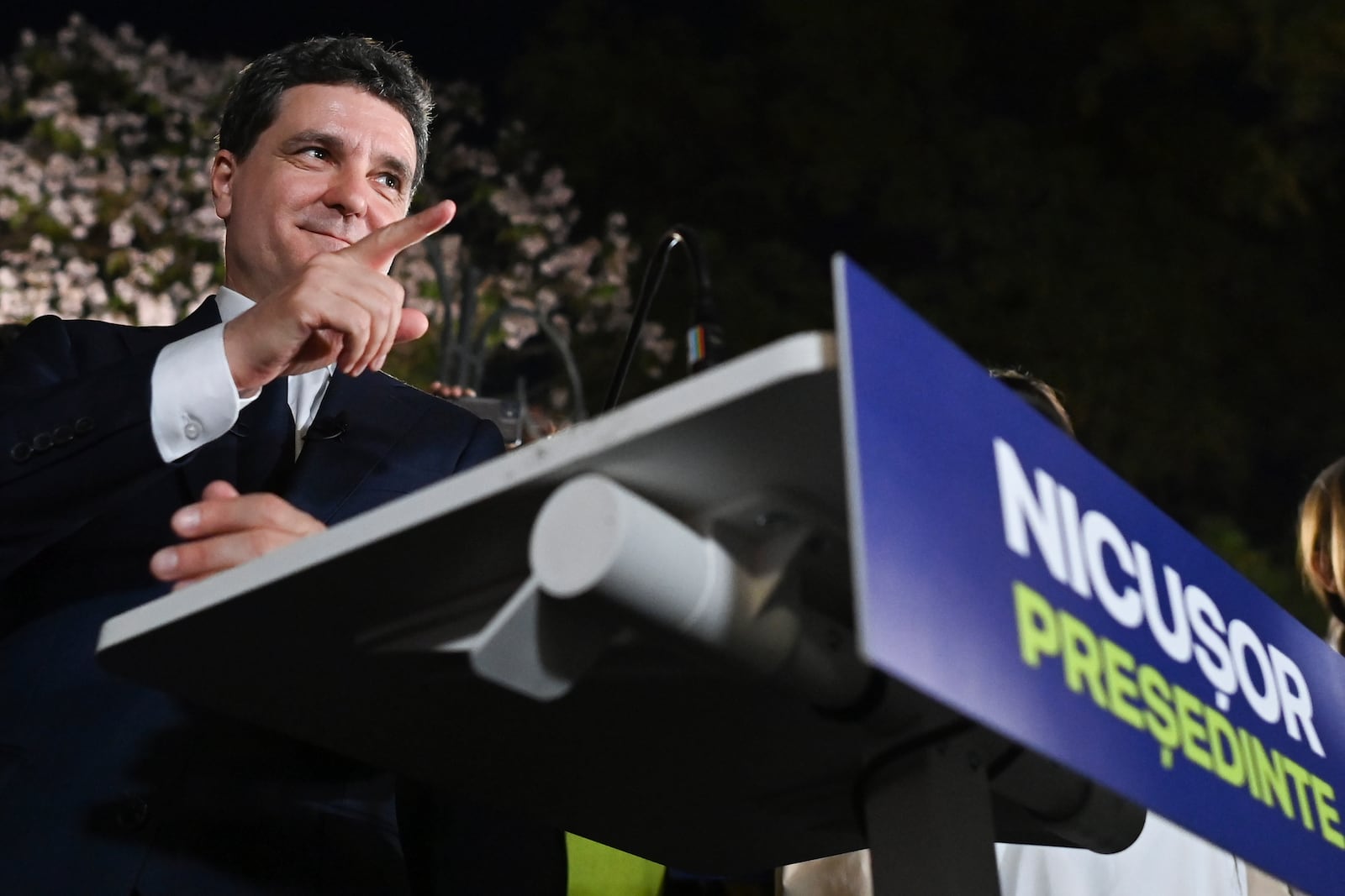 Presidential candidate Nicusor Dan gestures as he addresses supporters after polls closed for the first round of the country's presidential election redo in Bucharest, Romania, Sunday, May 4, 2025. (AP Photo/Eduard Vinatoru)