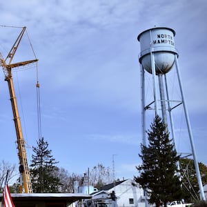 A new water tank went up Tuesday, Nov. 4, 2025 in the village of North Hampton, being placed on the top of a 140 foot cement pillar. Pictured is the new tank being installed next to the old water tower. Contributed Photo\MARSHALL GORBY
