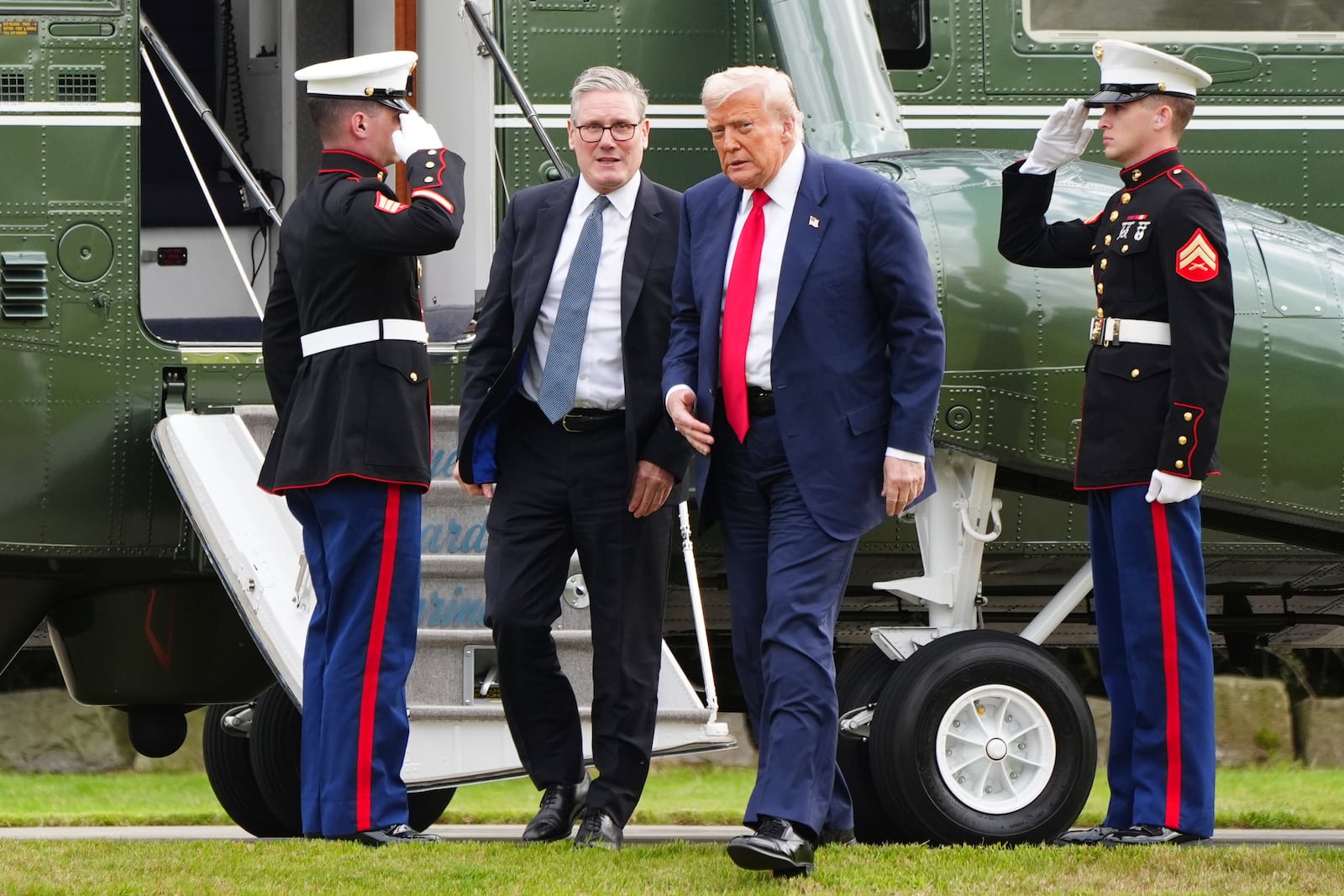 U.S. President Donald Trump, centre right, and British Prime Minister Keir Starmer arrive at Trump International Golf Links in Aberdeenshire, Scotland, Monday, July 28, 2025. (Jane Barlow/Pool Photo via AP)