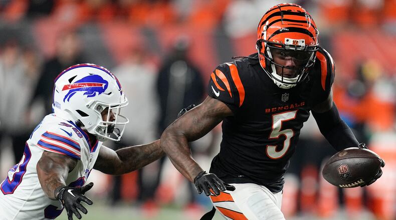 Cincinnati Bengals wide receiver Tee Higgins (5) runs with the ball as Buffalo Bills cornerback Dane Jackson tries to stop him during the second half of an NFL football game, Sunday, Nov. 5, 2023, in Cincinnati. (AP Photo/Darron Cummings)