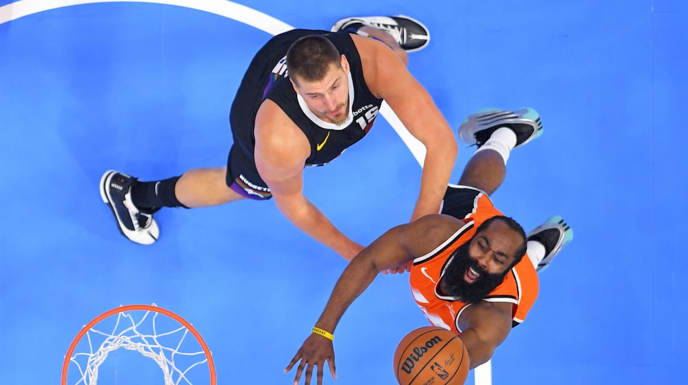 Los Angeles Clippers guard James Harden, right, shoots as Denver Nuggets center Nikola Jokic defends during the first half of an NBA basketball game Wednesday, Nov. 12, 2025, in Inglewood, Calif. (AP Photo/Mark J. Terrill)