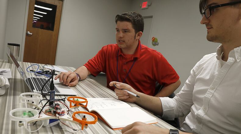 Dylan Bertram, right, helps Jesse Morris program a quadcopter at The Dome Wednesday. Bill Lackey/Staff