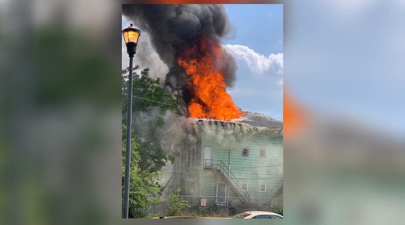 Flames shoot through the roof in a house fire on East Mulberry Street in Springfield on Friday, June 9, 2023. EMILY PARSONS/CONTRIBUTED