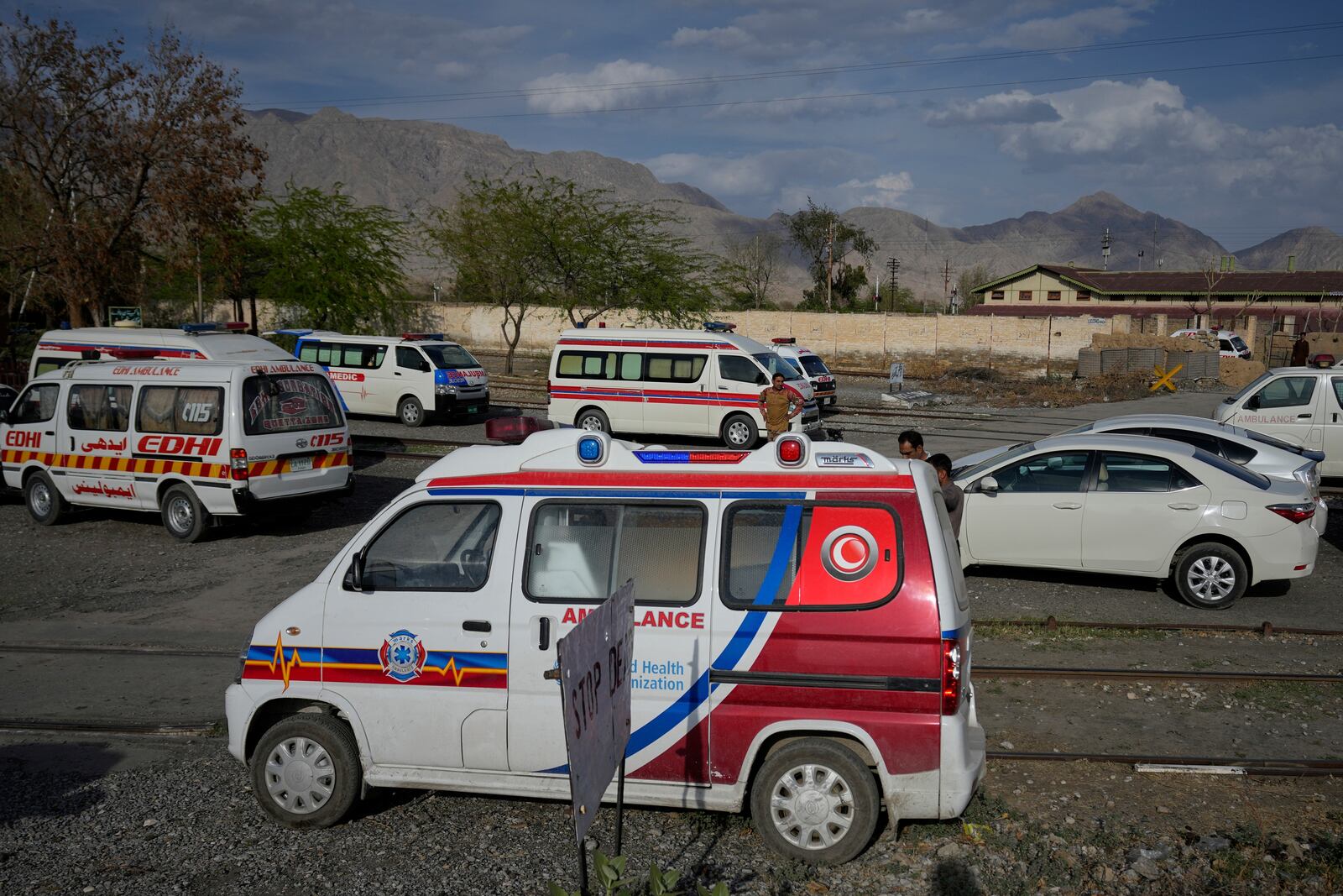 Ambulances park outside a railway station where rescued and injured passenger of a train attacked by insurgents are brought in Much, Pakistan's southwestern Balochistan province, Wednesday, March 12, 2025. (AP Photo/Anjum Naveed)