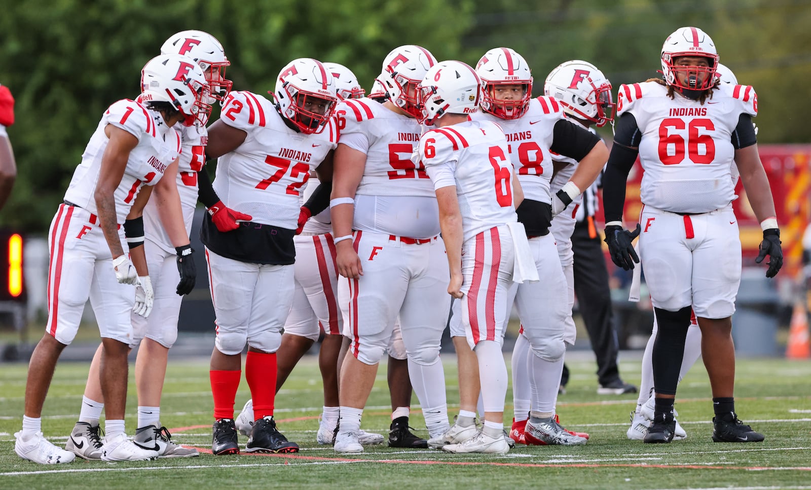 The Fairfield High School football team huddles up during their game against Wayne on Friday, Aug. 22 at Heidkamp Stadium in Huber Heights. The Warriors scored a late touchdown and held on to win 31-24. BRYANT BILLING / STAFF