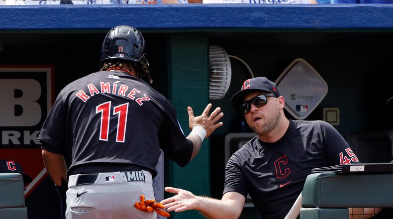 Cleveland Guardians Jose Ramirez (11) is congratulated by hitting coach Chris Valaika (45) after scoring off a Josh Naylor single during the eighth inning of a baseball game against the Kansas City Royals in Kansas City, Mo., Sunday, June 30, 2024. (AP Photo/Colin E. Braley)