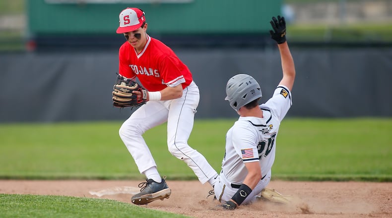 Southeastern High School sophomore shortstop Gehrig Cordial attempts to throw the ball to first base after making contact with Troy Christian's Camden Koukol during a Division IV district semifinal game on Monday, May 23, 2022, at Troy High School's Market Street Field. The Trojans won 3-0. Contributed photo by Michael Cooper