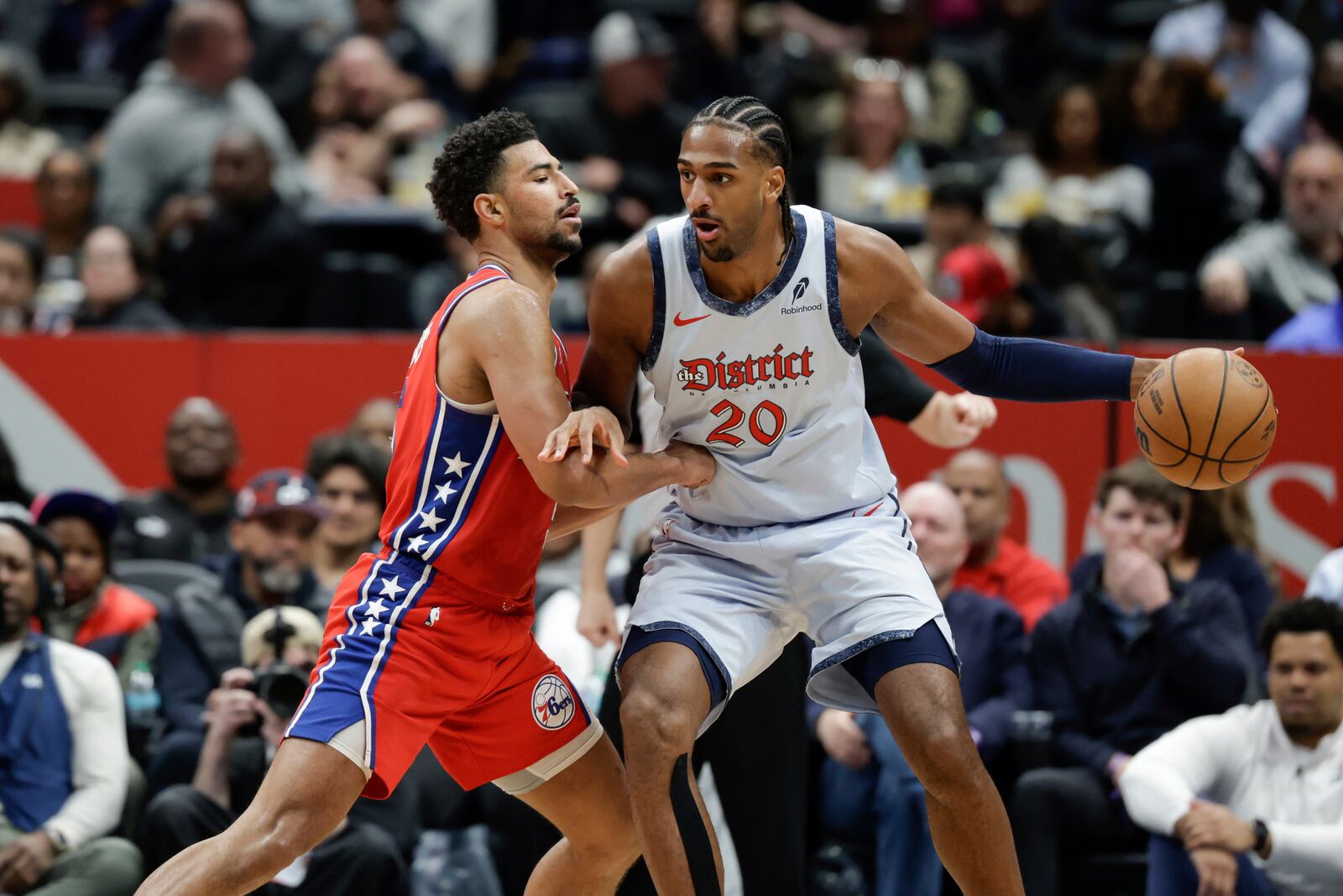 Washington Wizards forward Alex Sarr (20) handles the ball as Philadelphia 76ers forward Quentin Grimes defends during the second half of an NBA basketball game in Washington, Wednesday, April 9, 2025. (AP Photo/Terrance Williams)