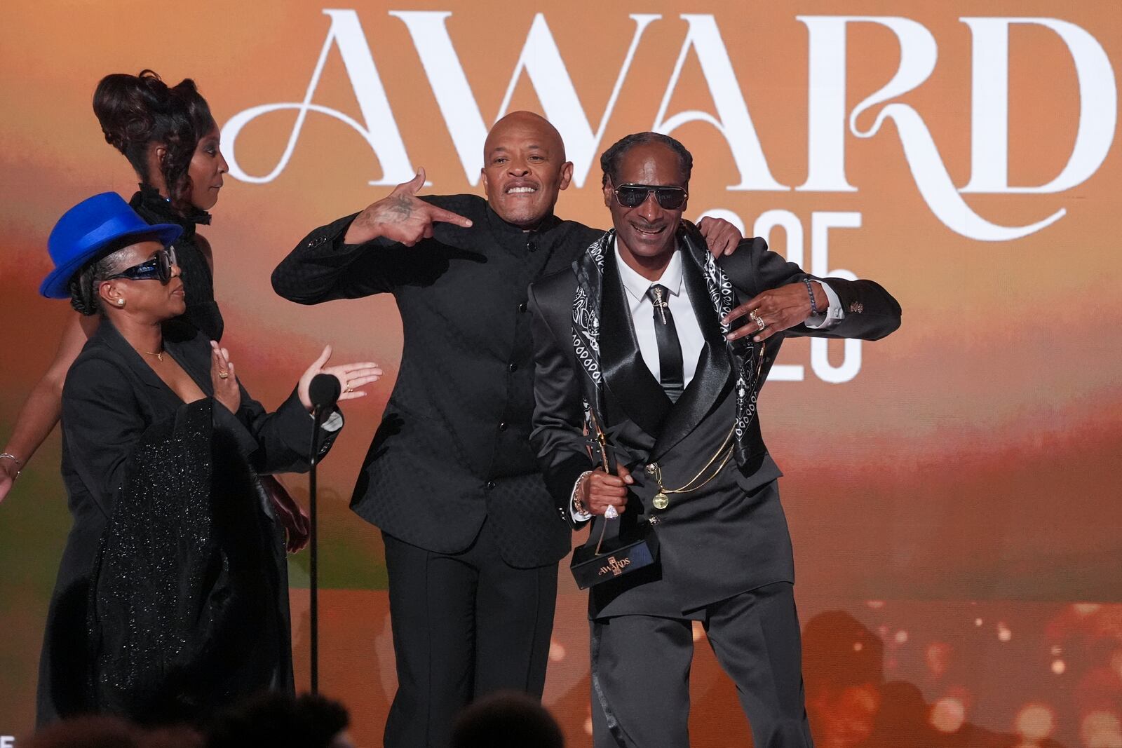 Dr. Dre, center, presents the ultimate icon award to Snoop Dogg during the BET Awards on Monday, June 9, 2025, at the Peacock Theater in Los Angeles. Shante Broadus looks on from left. (AP Photo/Chris Pizzello)