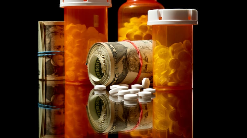 EDS.: RETRANSMISSION TO PROVIDE AN ALTERNATE CROP — An illustrative photo of prescription medications and rolls of cash, Dec. 5, 2024. A New York Times investigation details how pharmacy benefit managers, or PBMs, took billions of dollars from opioid manufacturers in return for not restricting painkiller prescriptions, as tens of thousands of Americans overdosed and died. (Jens Mortensen/The New York Times)