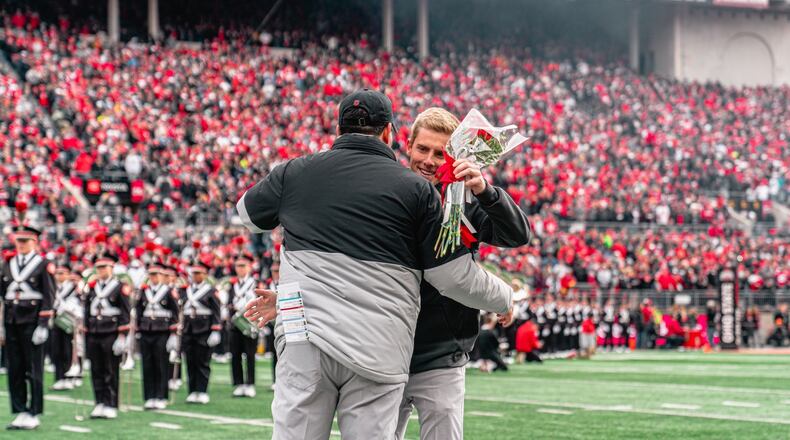 Ohio State football manager Austin Edwards of Springboro hugs head coach Ryan Day in middle of Ohio Stadium on Senior Day. CONTRIBUTED
