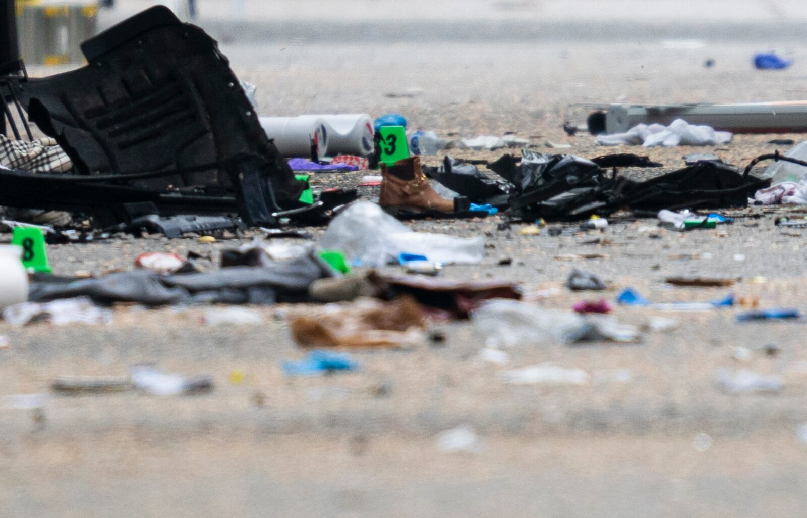 Debris and evidence markers lay on the street while police investigate after a vehicle drove into a crowd at a street festival Saturday evening killing multiple people, in Vancouver, British Columbia, Sunday, April 27, 2025. (Rich Lam/The Canadian Press via AP)