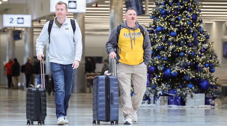 Passengers walk through the terminal at James M. Cox Dayton International Airport on Thursday, Dec. 11. AAA projects 122.4 million Americans will travel at least 50 miles from home over the 13-day year-end holiday period beginning Dec. 20 and ending Jan. 1. This will be the first time on record that the number of domestic air travelers over the year-end holiday period exceeds eight million. BRYANT BILLING/STAFF