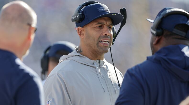 FILE - Seattle Seahawks defensive coordinator Aden Durde talks with coaches during the first half of an NFL football game against the Tennessee Titans, Nov. 23, 2025, in Nashville, Tenn. (AP Photo/Stew Milne, File)