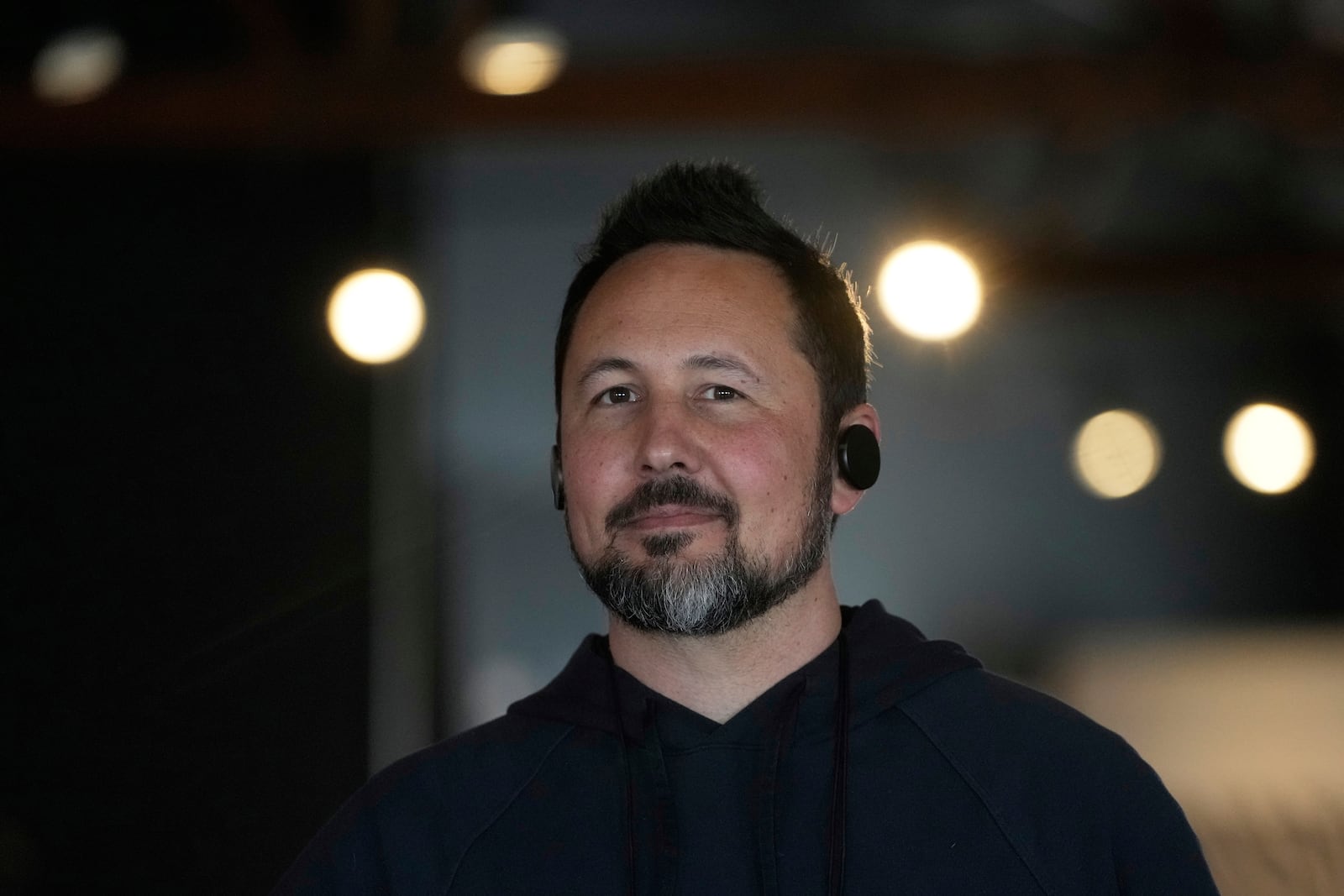 FILE - Jason Rugolo, founder and CEO of iyO, wears the iyO One audio computer in his ears while being interviewed at the company's office in Redwood City, Calif., Tuesday, June 24, 2025. (AP Photo/Jeff Chiu, File)